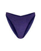 Frontal view of cheeky bikini bottoms with a ruched detailing on the back seam in a navy blue with a shimmer, mid-rise and in a ribbed textured fabric.